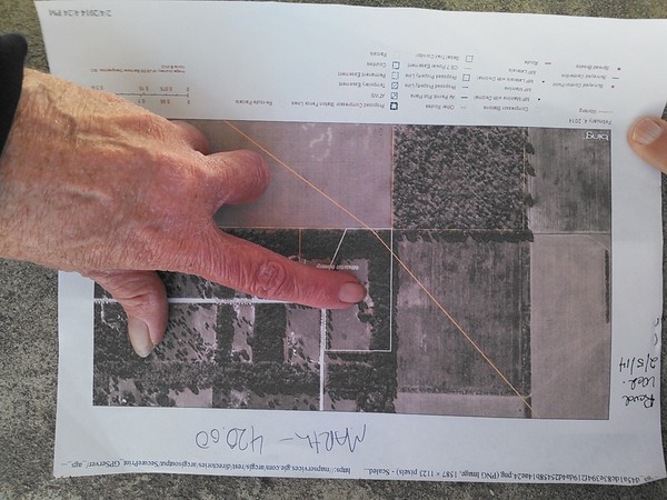 Marty Marth pointing out pipeline path on her property, in Gilchrist County Commission, by John S. Quarterman, for SpectraBusters.org, 20 February 2014